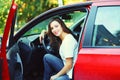 Beautiful smiling young woman driver behind wheel red car Royalty Free Stock Photo