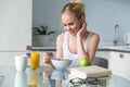 beautiful smiling young woman eating muesli for breakfast