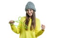 Beautiful smiling young woman with empty clothes hanger, autumn winter season, girl in sweater and knitted hat, isolated on white Royalty Free Stock Photo