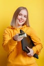 Beautiful smiling young woman freelancer with laptop take dollars money banknotes. IT remote freelancer remote worker Royalty Free Stock Photo