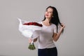 Beautiful young woman with a large bouquet of red roses Royalty Free Stock Photo