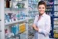 Beautiful smiling young woman pharmacist doing his work in pharmacy. Royalty Free Stock Photo