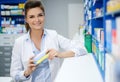 Beautiful smiling young woman pharmacist doing his work in pharmacy. Royalty Free Stock Photo