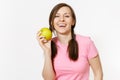 Beautiful smiling young woman with pigtails in pink t-shirt holding in hands green apple isolated on white background Royalty Free Stock Photo