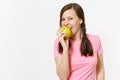 Beautiful smiling young woman with pigtails in pink t-shirt holding in hands green apple isolated on white background Royalty Free Stock Photo