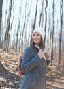 Beautiful happy smiling young woman portrait in forest wearing winter clothes Royalty Free Stock Photo