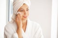 Beautiful smiling young woman removing makeup with a facial wipe Royalty Free Stock Photo