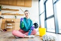 beautiful smiling young woman in rubber gloves holding plastic bottles with cleaning Royalty Free Stock Photo