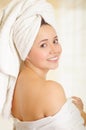 Beautiful smiling young woman with a white towel covering her head is posing Royalty Free Stock Photo