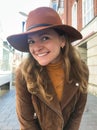 Beautiful smilling woman in brown hat looking at camera