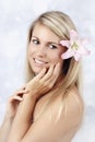 Beautiful smilling woman with lily in her hair