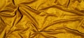 Beautiful smooth elegant wavy golden yellow mustard satin silk luxury cloth fabric texture, abstract background design pattern, Royalty Free Stock Photo