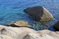 Beautiful smooth eroded granite rocks and green Mediterranean water Royalty Free Stock Photo