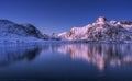 Snowy mountains and colorful sky reflected in water at sunset Royalty Free Stock Photo