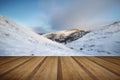 Beautiful snow covered sunrise Winter rural landscape with wooden planks floor Royalty Free Stock Photo