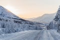 beautiful snow covered winter road with road sign and trees in mountains, Royalty Free Stock Photo