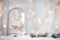 Beautiful snow globe against blurred Christmas lights. Space for text Royalty Free Stock Photo