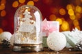 Beautiful snow globe, Christmas bauble and gifts on wooden table against blurred festive lights Royalty Free Stock Photo