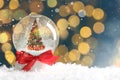 Beautiful snow globe with Christmas tree against blurred lights, space for text. Bokeh effect Royalty Free Stock Photo