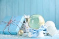 Beautiful snow globe, gift box and Christmas decor on light blue table