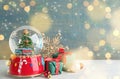 Beautiful snow globe, gift boxes and Christmas decor on white table, space for text. Bokeh effect