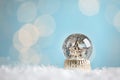 Beautiful snow globe with stars against blurred Christmas lights. Space for text Royalty Free Stock Photo