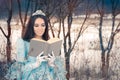 Beautiful Snow Queen Reading a Book Royalty Free Stock Photo