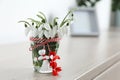 Beautiful snowdrops with traditional martisor on table indoors, space for text. Symbol of first spring day