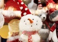 Beautiful snowman toy close up. Fluffy Christmas toys. Smiling snowman toy in a red hat close up Royalty Free Stock Photo