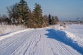 A beautiful snowy country road outside the city on a sunny winter day. Traffic in winter. Royalty Free Stock Photo