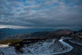 Beautiful snowy landscape with a road crossing the valley Royalty Free Stock Photo