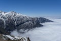 Beautiful snowy mountains risen above clouds at Himalaya mountains during sunny day Royalty Free Stock Photo