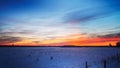 Beautiful snowy winter landscape panorama with agricultural field and sun. winter sunset in a panoramic view of the countryside Royalty Free Stock Photo