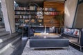 Beautiful sofa set against bookshelf in luxurious hotel room