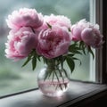 Soft pink peonies in a glass vase