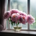 Soft pink peonies in a glass vase