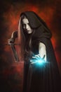 Beautiful sorceress in fighting position with sword Royalty Free Stock Photo