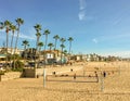 Beautiful Southern California beach scene with volleyball, palm trees, sunshine, and waterside homes Royalty Free Stock Photo