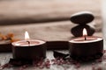 Beautiful Spa composition with aroma candles and empty vintage open book on wooden background. Royalty Free Stock Photo