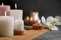 Beautiful spa composition with burning candles on dark grey table. Space for text Royalty Free Stock Photo