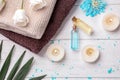 Beautiful spa composition with cosmetic products, flowers and candles on wooden background, top view Royalty Free Stock Photo