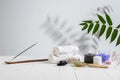 Beautiful spa composition on massage table in wellness center, copyspace. Leaves` shadows on the wall Royalty Free Stock Photo