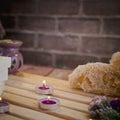 Beautiful spa composition with natural soaps with scented candles and bathroom accessories in a romantic setting for a cleansing Royalty Free Stock Photo