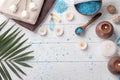 Beautiful spa composition with sea salt, flowers and candles on wooden background, top view Royalty Free Stock Photo