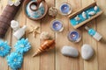 Beautiful spa composition with sea salt, flowers and candles on wooden background, top view Royalty Free Stock Photo