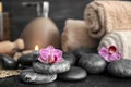 Beautiful spa composition with stones and orchid flowers on table Royalty Free Stock Photo