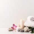 Beautiful spa composition of towels, white burning candles, purple orchid flowers, grey stones on light background. Copy Royalty Free Stock Photo