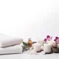 Beautiful spa composition of towels, white burning candles, purple orchid flowers, grey stones on light background. Copy Royalty Free Stock Photo