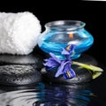 Beautiful spa concept of iris flower, blue candle, white towel a Royalty Free Stock Photo
