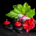 Beautiful spa concept of red hibiscus flower with dew, candles, Royalty Free Stock Photo